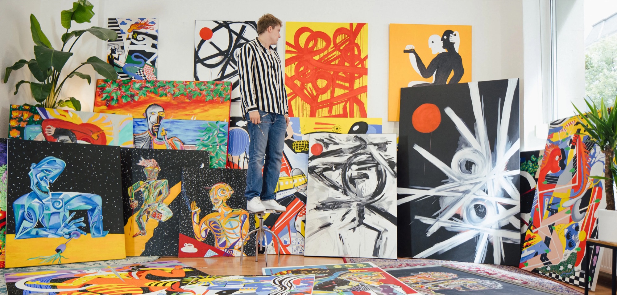 Overview of paintings by David Herbrechter laid out in the studio
